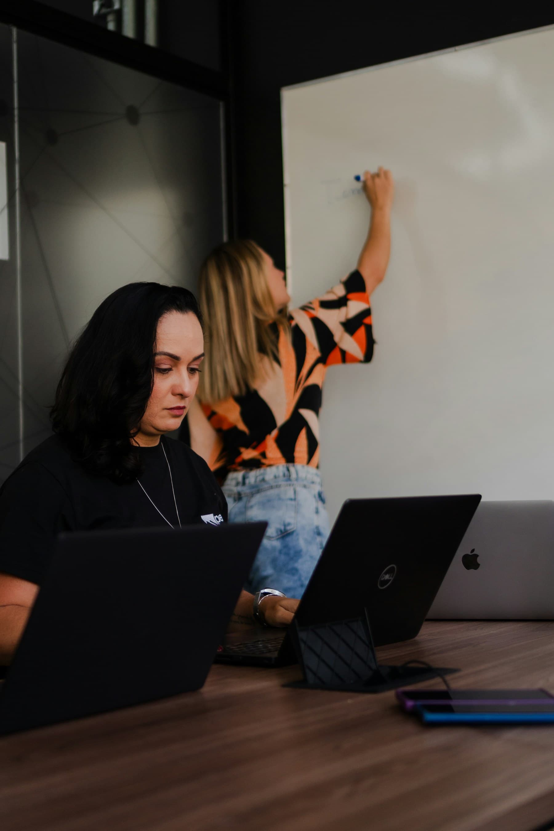 A team shaping a digital product around a whiteboard
